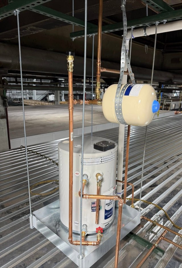 Water heater and expansion tank installed on a stand with new copper piping